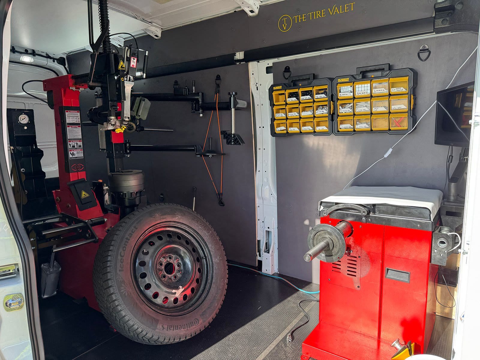 Interior of The Tire Valet van with a tire changer and wheel balancer