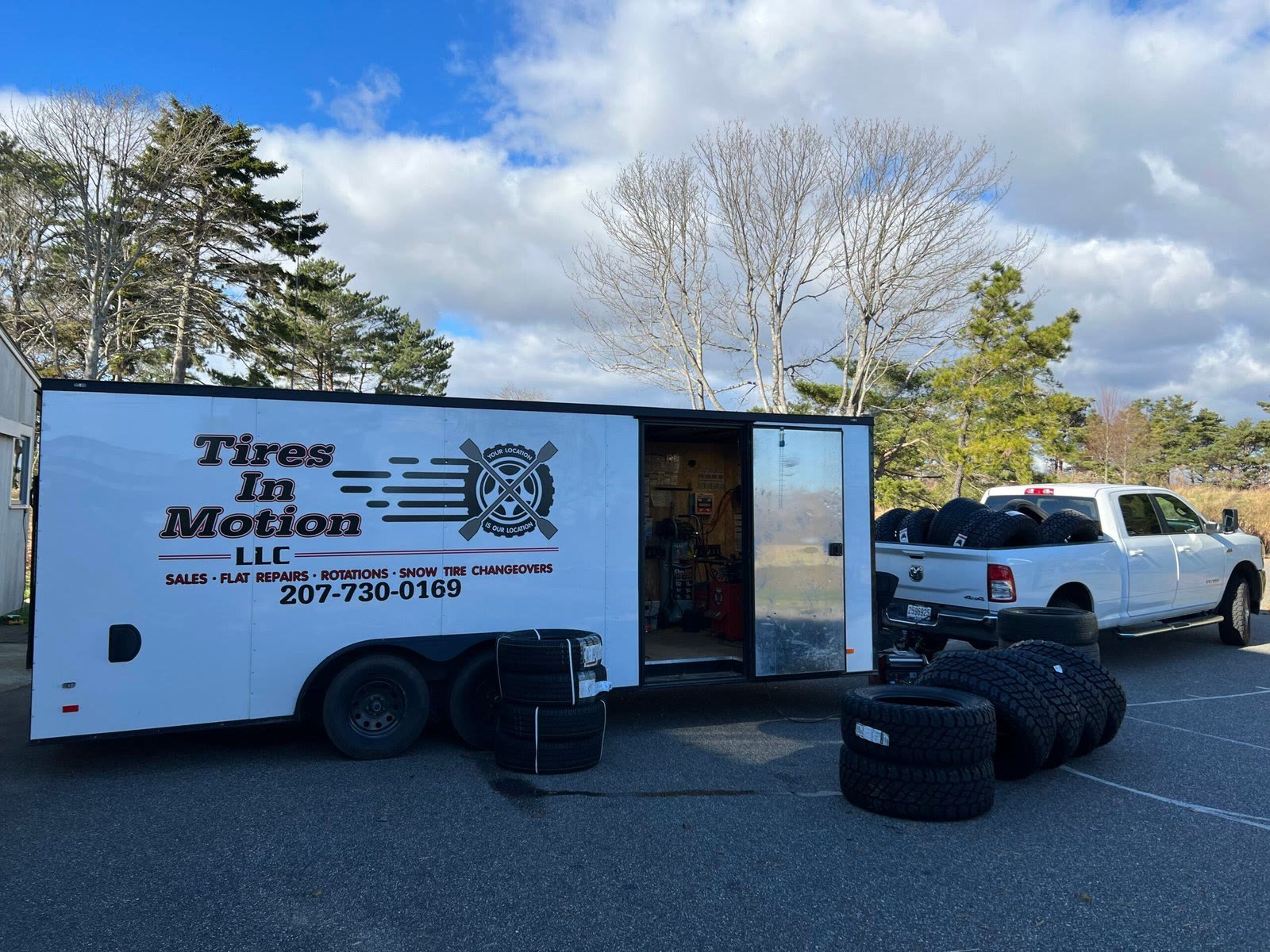 Tires In Motion trailer and pickup at a job site